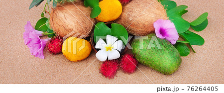 Tropical fruit on a sandy beach. Wide photo. Tropical fruit on a sandy beach. Wide photo. 76264405