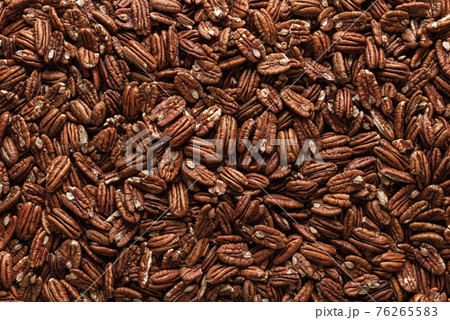 Pecan nuts background, top view. Pecans fruits texture, close-up 76265583