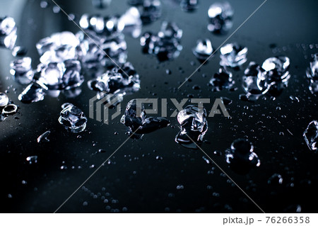 pile of different ice cubes on reflection table on black background  76266358
