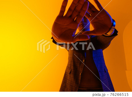 Young good looking asian business man on a yellow background 76266515