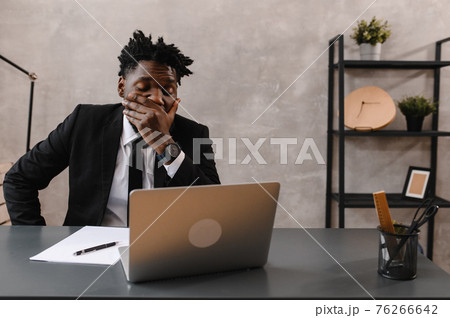 Black Businessman using laptop for analyzing data stock market, forex trading graph, stock exchange trading online. reaction to falling stocks Black Businessman using laptop for analyzing data stock market, forex trading graph, stock exchange trading online. reaction to falling stocks 76266642