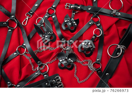 A set of erotic toys for BDSM. Sex slavery game with whip, gag and leather face mask. Intimate sex games leather belts A set of erotic toys for BDSM. Sex slavery game with whip, gag and leather face mask. Intimate sex games leather belts 76266973