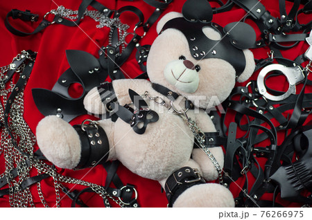 A set of erotic toys for BDSM. Sex slavery game with whip, gag and leather face mask. Intimate sex games leather belts 76266975