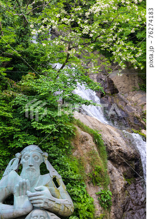 Waterfall and monument of St. Andrew near Sarpi town in Adjara, Georgia 76274183