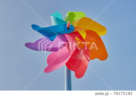 Low Angle Rainbow Pinwheel on Blue Sky Background Low Angle Rainbow Pinwheel on Blue Sky Background 76275282