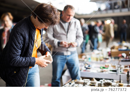 Woman visiting flea market Woman visiting flea market 76277372
