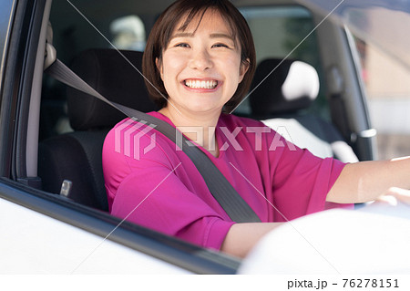 車を運転する若い女性 76278151