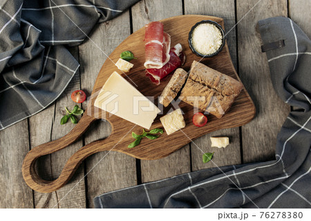 Italian cuisine concept. Parmesan Cheese, ham slice, tomato, basil, bread, toast 76278380
