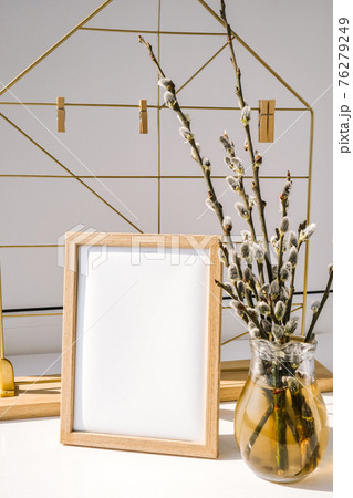 Mock up interior Picture frame with Willow branch in glass vase. Brunch of the blossoming pussywillow on early spring. Easter spring still life Mock up interior Picture frame with Willow branch in glass vase. Brunch of the blossoming pussywillow on early spring. Easter spring still life 76279249