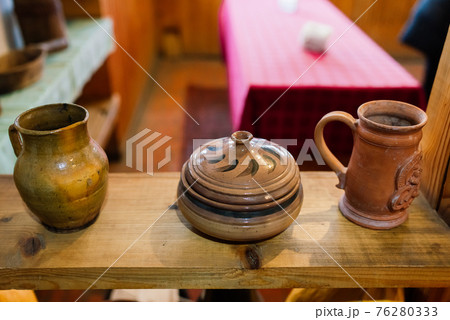 Ancient interior of a rural house in an ethnographic park. Old stove Ancient interior of a rural house in an ethnographic park. Old stove 76280333