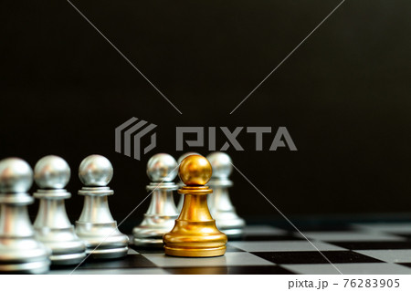 Gold pawn piece stand in fron of silver pawn team on black background (Concept for leader, unique or outstanding) 76283905
