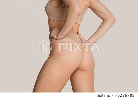 Beautiful female body in nude color underwear - Stock Photo