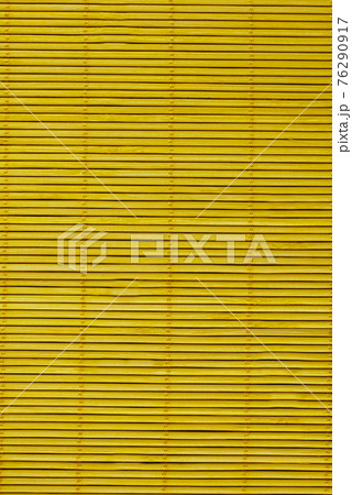 Wooden blinds on the mustard-colored windows.Texture or background 76290917