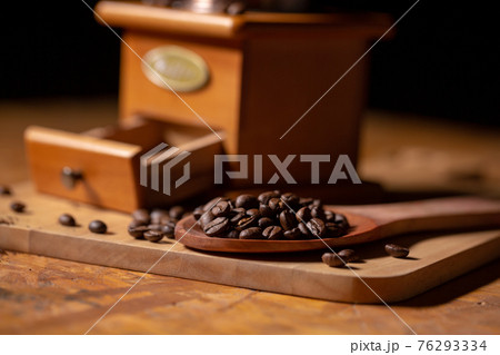 ..Manual coffee grinder placed on a wooden floor. 76293334