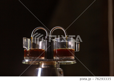 Heat vapor emitted from the coffee machine. 76293335
