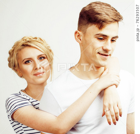 young pretty teenage couple, hipster guy with his girlfriend happy smiling and hugging isolated on white background, lifestyle people concept 76293507