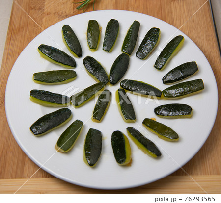 Preparing fresh cooked courgette, zucchini on wood table 76293565