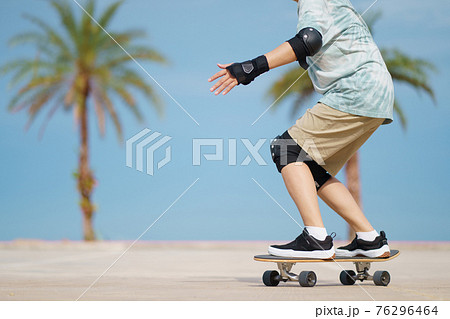 Hello Summer Surfers people Asian having fun with surfboards or surf skate around city streets background on a summer day. Free relax lifestyle and millennial trend concept 76296464