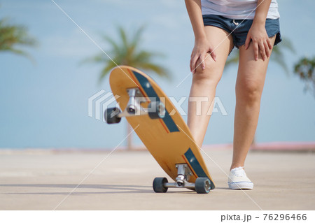 Hello Summer Surfers people Asian having fun with surfboards or surf skate around city streets background on a summer day. Free relax lifestyle and millennial trend concept 76296466