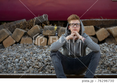 Young handsome teenage boy at the railway train station 76296730