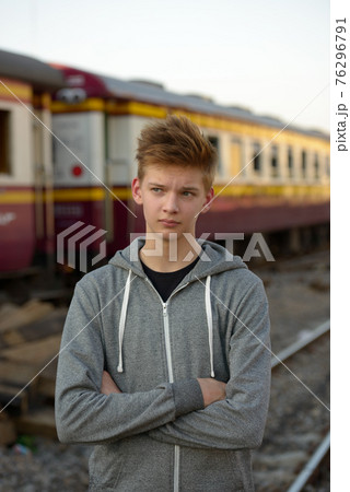 Young handsome teenage boy at the railway train station 76296791