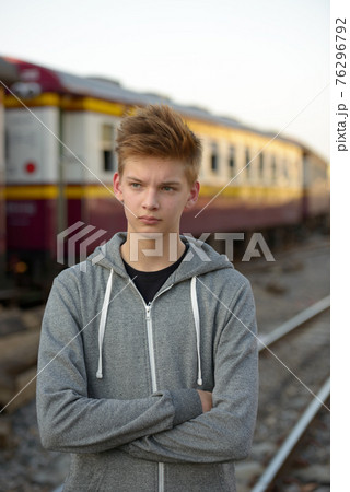 Young handsome teenage boy at the railway train station 76296792