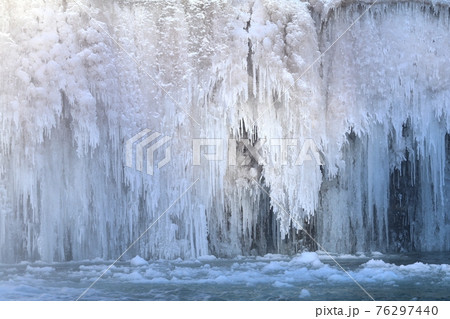 Beautiful icefall on river during winter 76297440