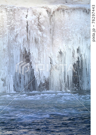 Beautiful icefall on river during winter Beautiful icefall on river during winter 76297443