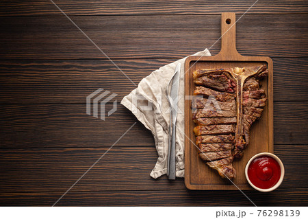 Sliced grilled T-bone beef steak from above and copy space 76298139