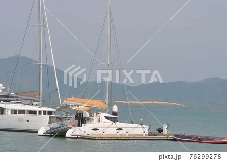 yacht or fishing boats near the sea at the port in Phuket 76299278
