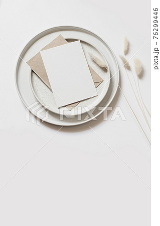 Modern summer, fall still life photo. Beige ball shaped vase with dry festuca grass in sunlight with long shadows. Beige table wall background. Empty copy space. Elegant lifestyle decorative scene. Modern summer, fall still life photo. Beige ball shaped vase with dry festuca grass in sunlight with long shadows. Beige table wall background. Empty copy space. Elegant lifestyle decorative scene. 76299446