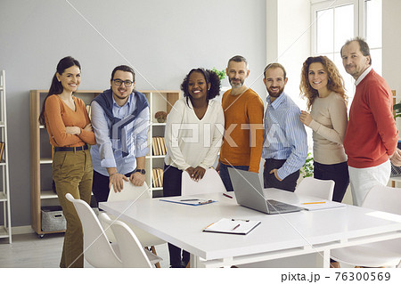 Portrait of happy diverse business team standing in office after successful work meeting 76300569