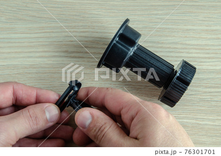 furniture black plastic support for kitchen set, on wooden background. furniture black plastic support for kitchen set, on wooden background. 76301701