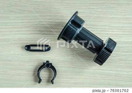 furniture black plastic support for kitchen set, on wooden background. 76301702