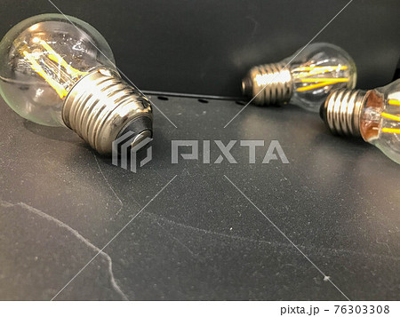 glass lamp, electrician for the apartment. incandescent light bulb for light in the house. bright chandeliers, glass bulbs with a light element inside 76303308