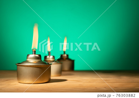 Pelita or oil lamp, traditional Malay oil lamp lit up during Ramadan and Hari Raya Aidilfitri Muslim celebration Pelita or oil lamp, traditional Malay oil lamp lit up during Ramadan and Hari Raya Aidilfitri Muslim celebration 76303882