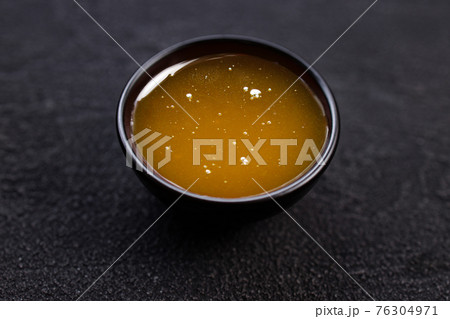 Honey sauce dip in bowl, close up. 76304971
