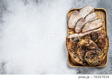 Roast sliced pork knuckle. Leg meat. Gray background. Top view. Copy space Roast sliced pork knuckle. Leg meat. Gray background. Top view. Copy space 76307639