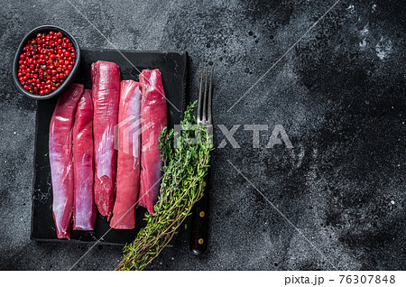 Fresh Raw lamb tenderloin Fillet, Mutton Sirloin Meat on marble board with thyme. Black background. Top view. Copy space Fresh Raw lamb tenderloin Fillet, Mutton Sirloin Meat on marble board with thyme. Black background. Top view. Copy space 76307848