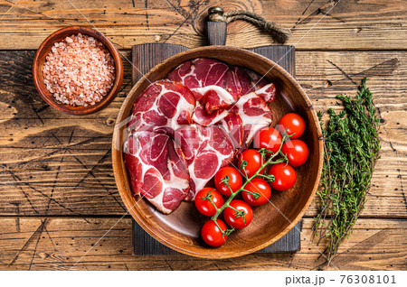 Italian sliced cured coppa ham with spices. wooden background. Top view 76308101