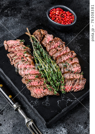 Skirt machete grilled meat beef Steak. Black background. Top view 76308381