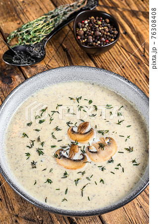 Mushroom cream soup in a plate. Wooden background. Top view Mushroom cream soup in a plate. Wooden background. Top view 76308408