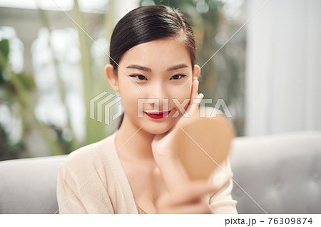 Asian pretty woman holding mirror 76309874