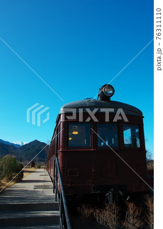 梅咲く早春の安曇野ちひろ公園内の電車 76311110