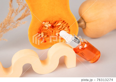 Still life composition, dropper bottle of modern organic cosmetics - natural pumpkin seeds oil extract for skincare or hair with pumpkins and plaster figures. Beauty treatment and spa concept Still life composition, dropper bottle of modern organic cosmetics - natural pumpkin seeds oil extract for skincare or hair with pumpkins and plaster figures. Beauty treatment and spa concept 76313274
