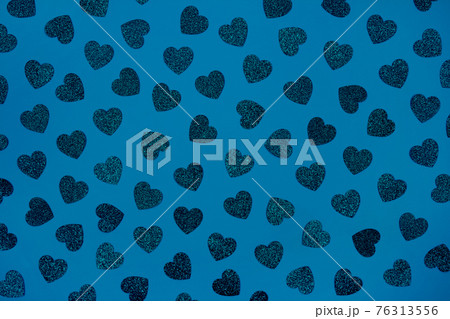 Festive blue background with glitter hearts - St. Valentine's Day celebration concept. Love backdrop for greeting card, copy space for your text, selective focus. Toned image Festive blue background with glitter hearts - St. Valentine's Day celebration concept. Love backdrop for greeting card, copy space for your text, selective focus. Toned image 76313556