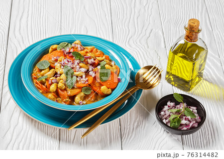 carrot curry with cashew and raisins, top view 76314482