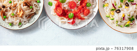 Konjac pasta panorama with copy space. Various vegetable toppings Konjac pasta panorama with copy space. Various vegetable toppings 76317908