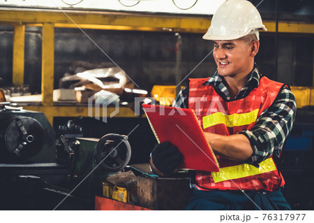 Manufacturing worker working with clipboard to do job procedure checklist . Manufacturing worker working with clipboard to do job procedure checklist . 76317977