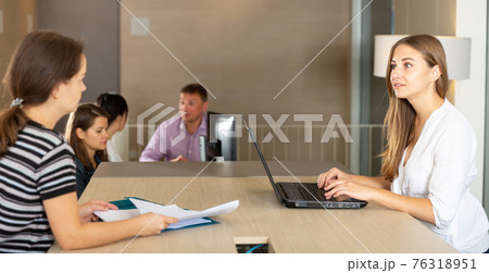 Two females discussing financial statements 76318951